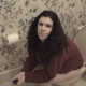 A brunette girl with long wild hair records herself farting loudly and repeatedly on the toilet. Nice audio with sighing and great farts!